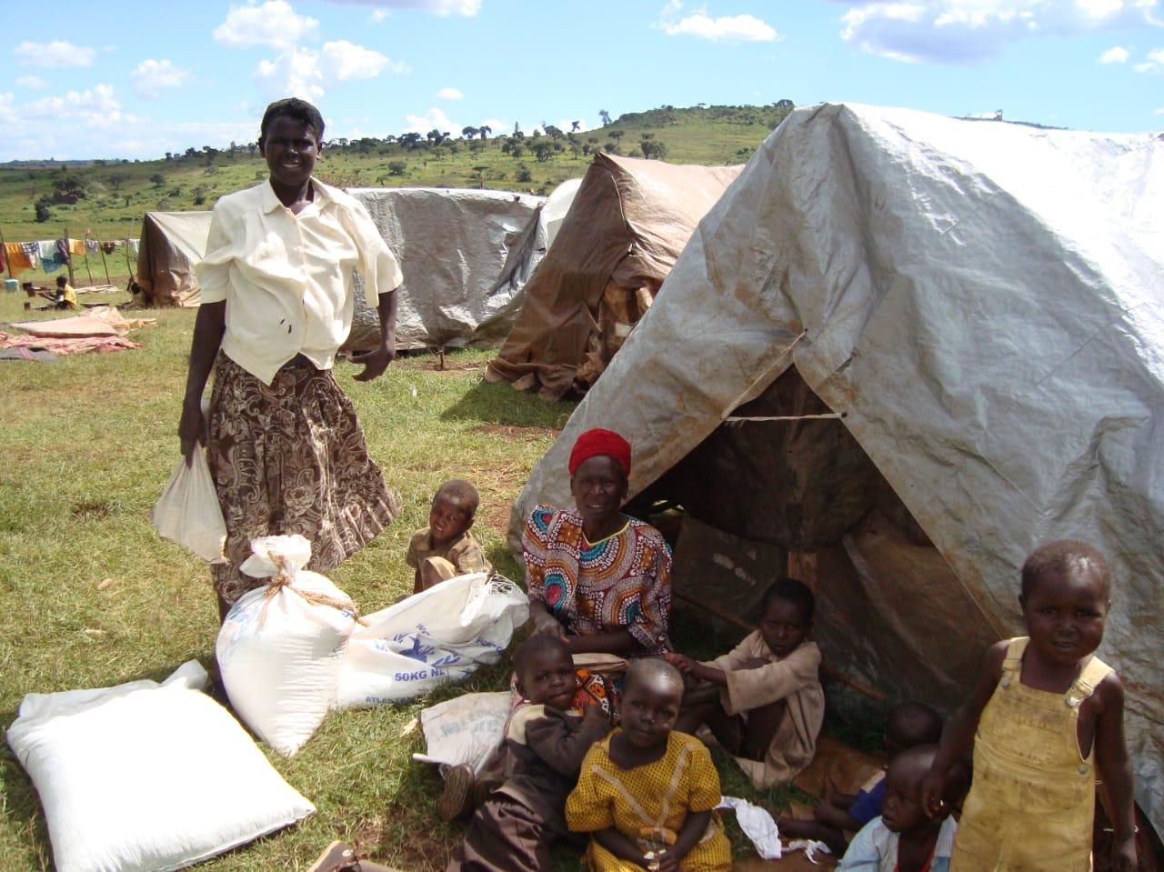 Humanitarian support scene with families near tents