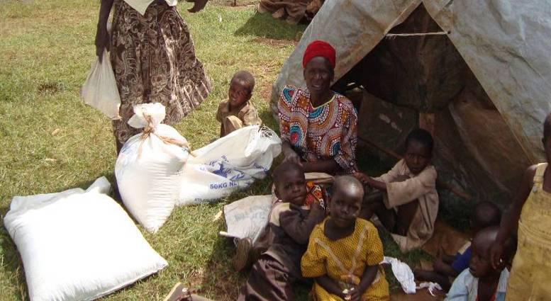 Close-up of a family near a tent with relief supplies